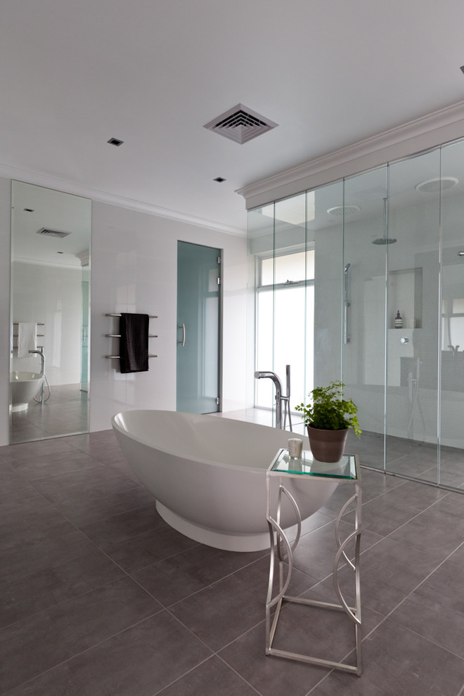 This is an example of an expansive contemporary ensuite bathroom in Perth with a freestanding bath, a double shower, grey tiles, ceramic tiles and white walls.