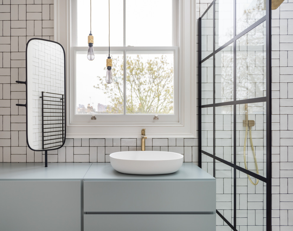 Medium sized contemporary family bathroom in London with flat-panel cabinets, blue cabinets, a walk-in shower, white tiles, a console sink, an open shower and blue worktops.