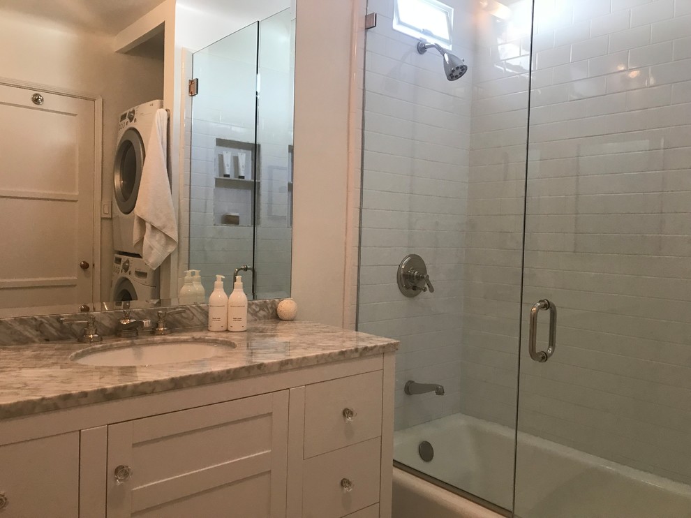 Inspiration for a small timeless master white tile and subway tile marble floor and gray floor bathroom remodel in Los Angeles with flat-panel cabinets, white cabinets, a two-piece toilet, white walls, an undermount sink, marble countertops and a hinged shower door