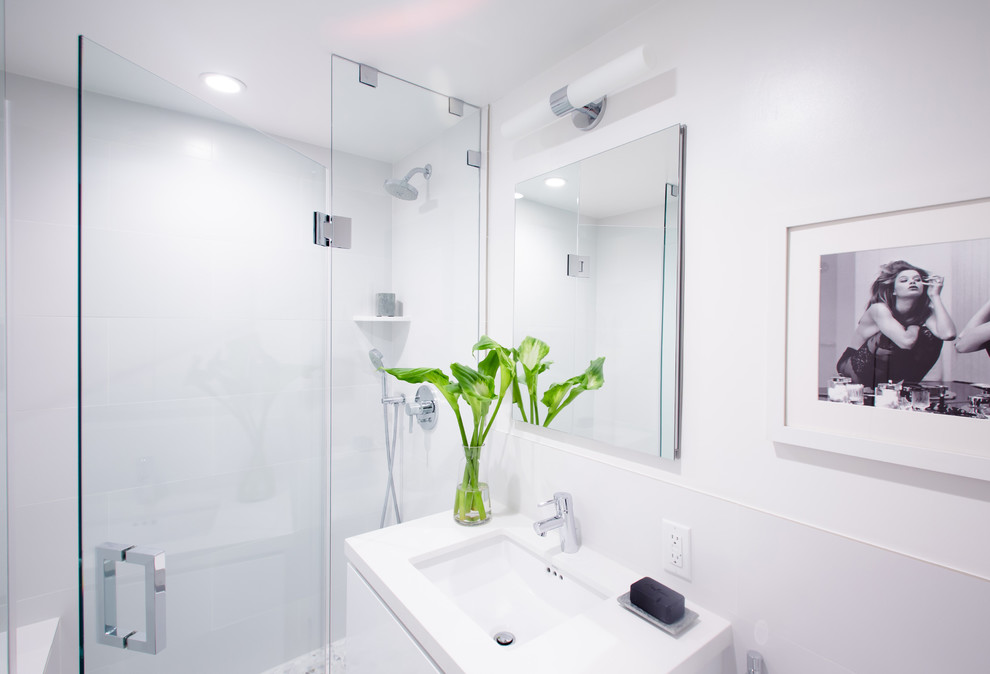 Inspiration for a medium sized contemporary shower room bathroom in Los Angeles with a submerged sink, flat-panel cabinets, white cabinets, engineered stone worktops, a one-piece toilet, white tiles, porcelain tiles, white walls and porcelain flooring.