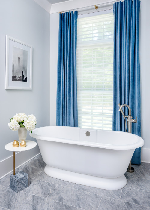 Elegant Oasis: Elegant Bathroom with a Freestanding Tub and Blue Curtains
