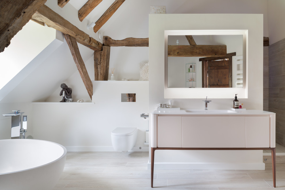 Inspiration for a rustic bathroom in London with a freestanding bath, an alcove shower, a wall mounted toilet, yellow walls, a console sink and an open shower.
