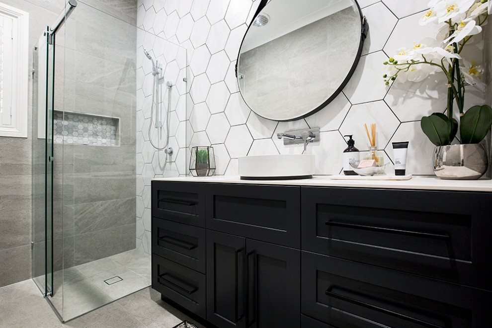 Inspiration for a large master black and white tile and ceramic tile ceramic tile and brown floor bathroom remodel in Sydney with shaker cabinets, black cabinets, white walls, a vessel sink, tile countertops, a hinged shower door and multicolored countertops