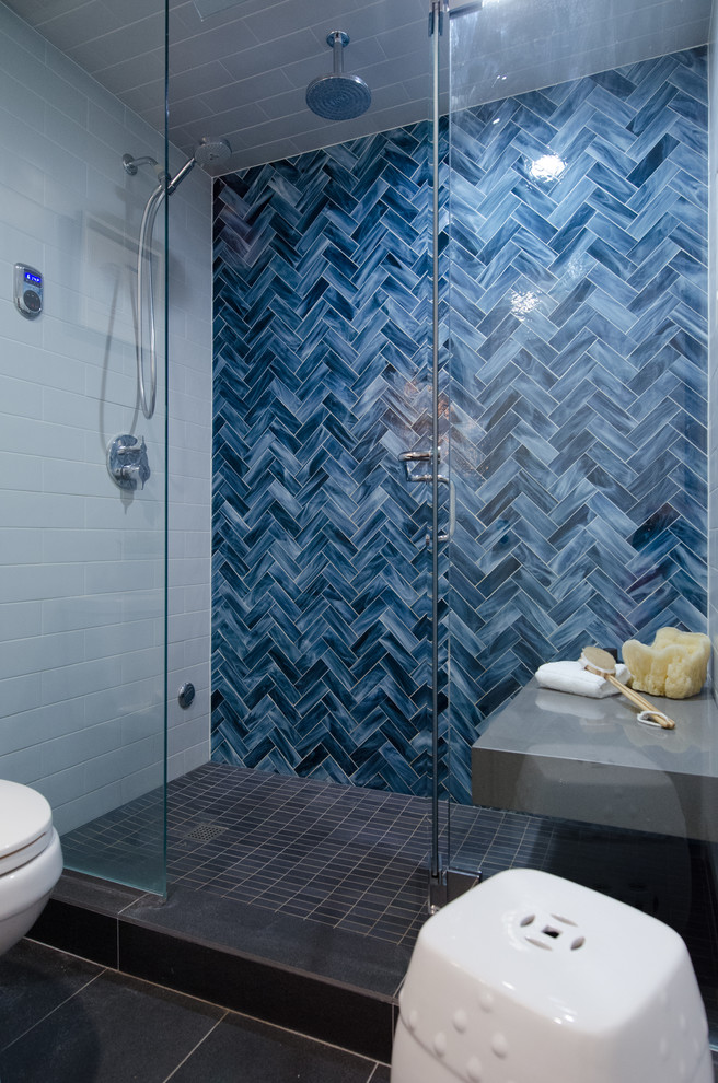 Design ideas for a small eclectic shower room bathroom in Seattle with shaker cabinets, dark wood cabinets, an alcove shower, a one-piece toilet, grey tiles, glass tiles, blue walls, porcelain flooring, a submerged sink and engineered stone worktops.