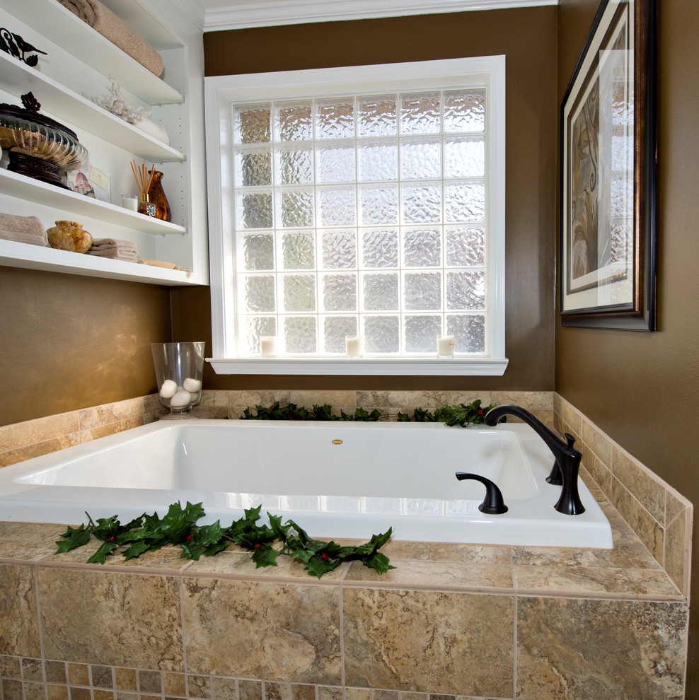 Medium sized traditional ensuite bathroom in Little Rock with a submerged sink, raised-panel cabinets, white cabinets, granite worktops, a built-in bath, a corner shower, a two-piece toilet, beige tiles, porcelain tiles, brown walls and porcelain flooring.