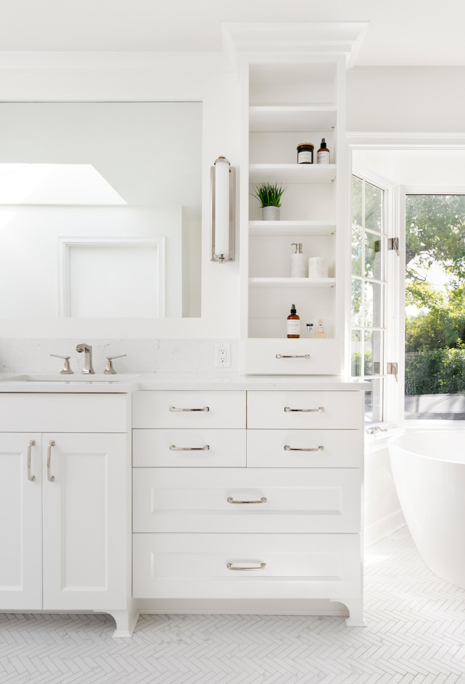 Inspiration for a large contemporary ensuite bathroom in Portland with a freestanding bath, white walls, white floors, white worktops, shaker cabinets, white cabinets, a built-in shower, grey tiles, porcelain tiles, porcelain flooring, a submerged sink, engineered stone worktops and a hinged door.