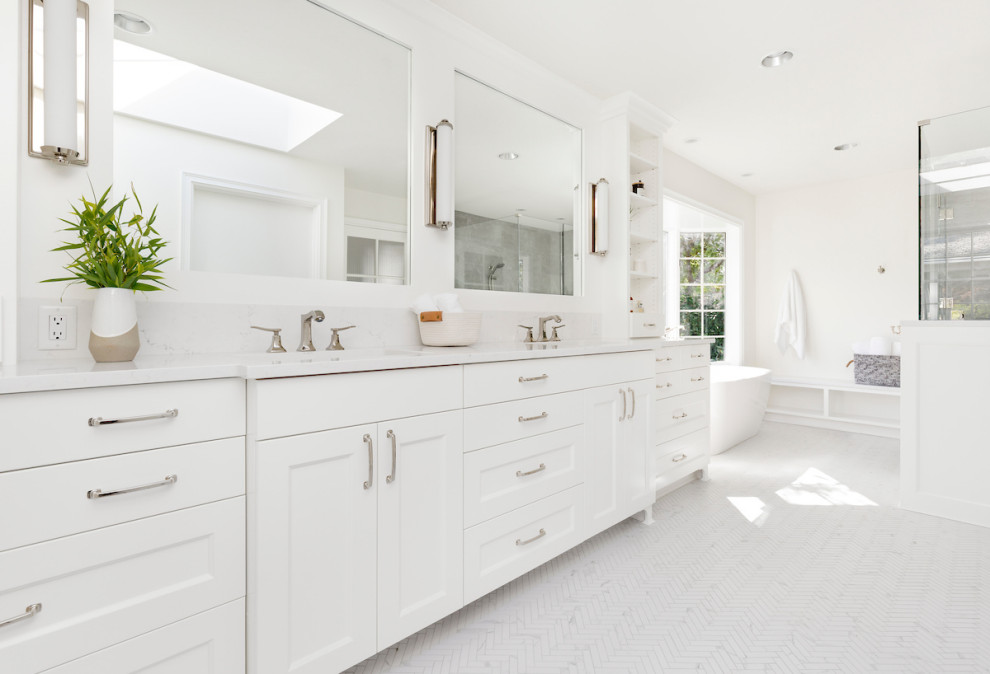 Inspiration for a large contemporary master gray tile and porcelain tile porcelain tile and white floor bathroom remodel in Portland with shaker cabinets, white cabinets, white walls, an undermount sink, quartz countertops, a hinged shower door and white countertops