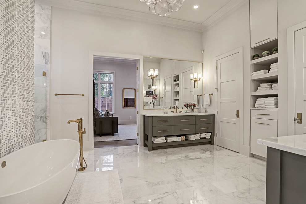 Example of a huge transitional master white tile and marble tile marble floor and white floor bathroom design in Houston with flat-panel cabinets, gray cabinets, a one-piece toilet, white walls, a drop-in sink, quartz countertops and gray countertops