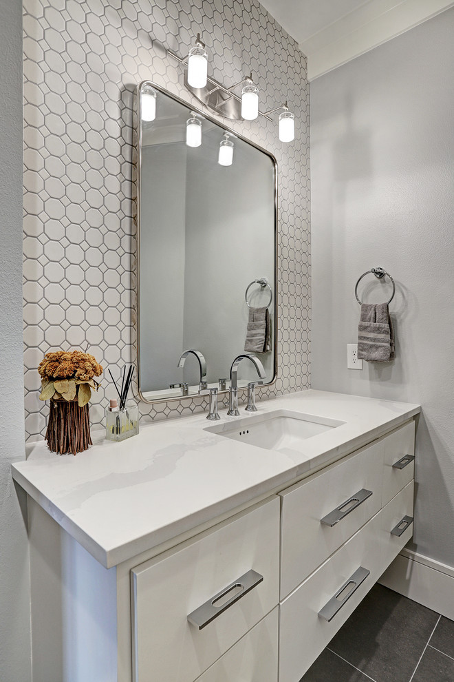 Photo of a medium sized traditional shower room bathroom in Houston with flat-panel cabinets, white cabinets, a freestanding bath, a corner shower, a one-piece toilet, grey tiles, marble tiles, white walls, ceramic flooring, a built-in sink, quartz worktops, grey floors and white worktops.