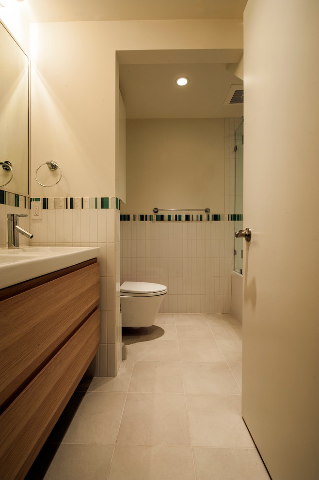 Drop-in bathtub - mid-sized mid-century modern 3/4 white tile and subway tile ceramic tile drop-in bathtub idea in Vancouver with an integrated sink, flat-panel cabinets, medium tone wood cabinets, solid surface countertops and white walls