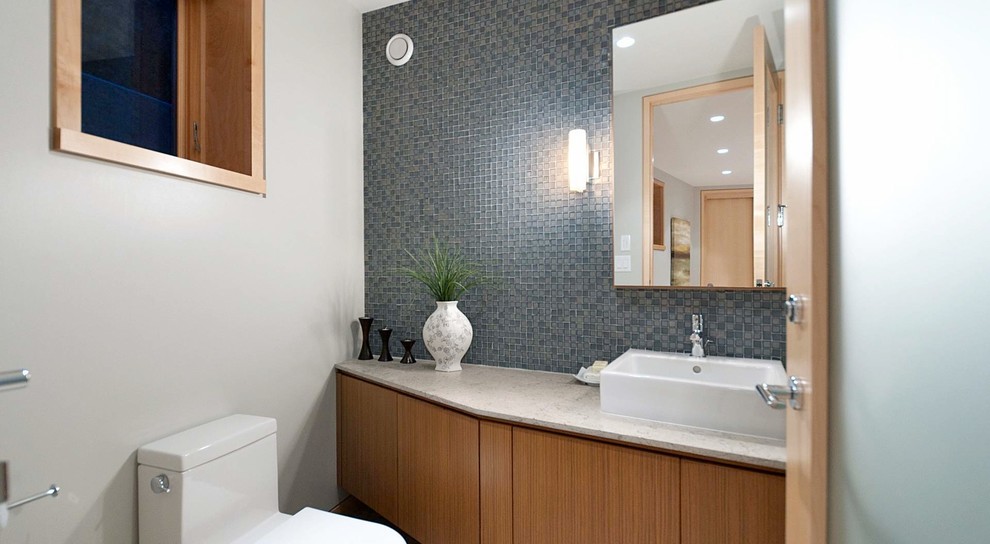 Mid-sized trendy 3/4 gray tile ceramic tile bathroom photo in Vancouver with a vessel sink, flat-panel cabinets, medium tone wood cabinets, granite countertops, a one-piece toilet and white walls