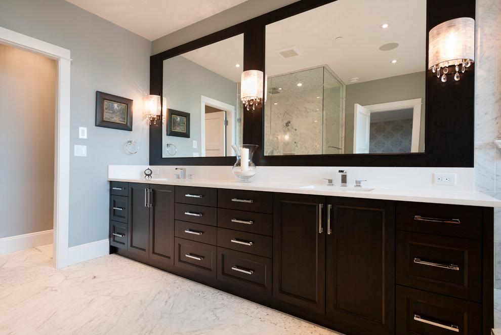 Large transitional master white tile and stone tile marble floor freestanding bathtub photo in Vancouver with an undermount sink, shaker cabinets, dark wood cabinets, marble countertops, a two-piece toilet and blue walls