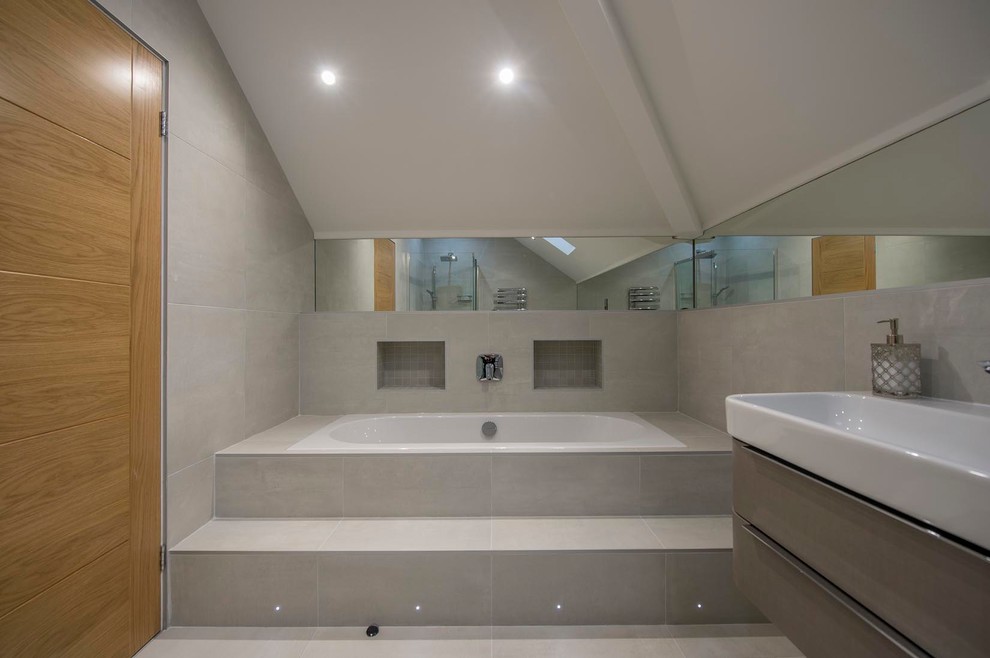 Large contemporary family bathroom in Other with flat-panel cabinets, a wall mounted toilet, grey tiles, ceramic tiles, grey walls, ceramic flooring and a trough sink.