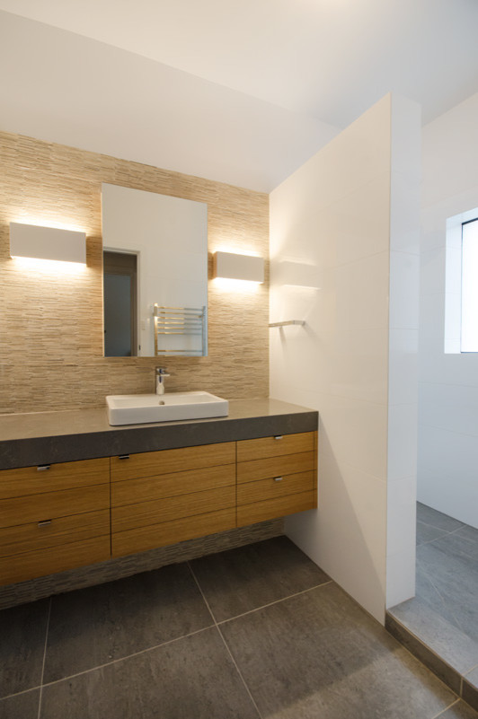 Example of a large mid-century modern mosaic tile and white tile porcelain tile and gray floor bathroom design in Melbourne with a drop-in sink, flat-panel cabinets, light wood cabinets, quartz countertops, a one-piece toilet and white walls