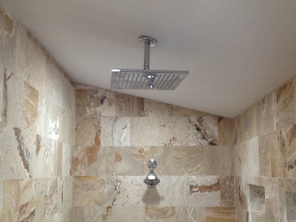 Doorless shower - huge transitional master beige tile and stone slab travertine floor doorless shower idea in Tampa with a vessel sink, shaker cabinets, dark wood cabinets, solid surface countertops, a hot tub, a one-piece toilet and beige walls
