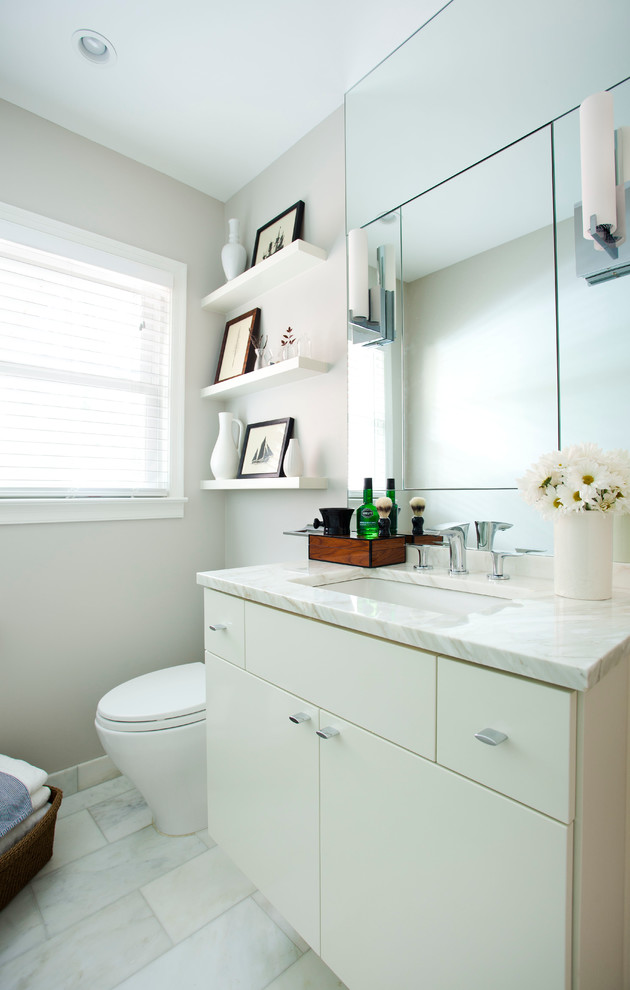 Inspiration för små moderna badrum, med ett undermonterad handfat, vita skåp, marmorbänkskiva, ett badkar i en alkov, en dusch/badkar-kombination, en toalettstol med hel cisternkåpa, vit kakel, tunnelbanekakel, grå väggar, marmorgolv och släta luckor