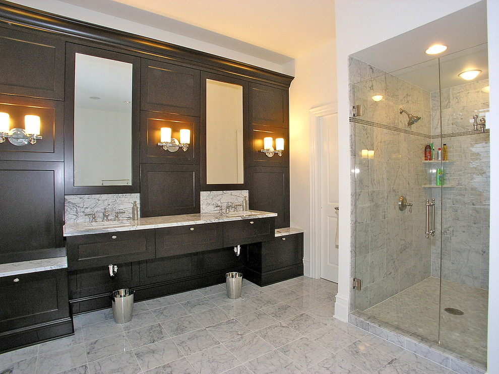 Corner shower - large transitional master slate floor corner shower idea in Grand Rapids with recessed-panel cabinets, beige walls, an undermount sink, marble countertops and dark wood cabinets