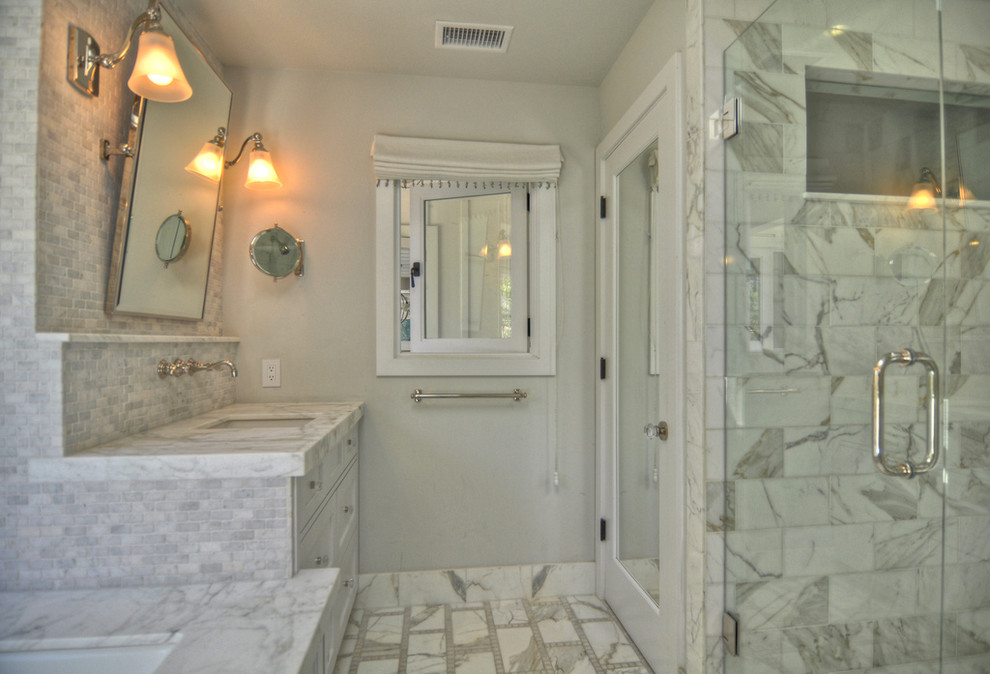 Inspiration for a large transitional master white tile marble floor alcove shower remodel in Orange County with an undermount sink, white cabinets, marble countertops, an undermount tub, shaker cabinets, a one-piece toilet and gray walls