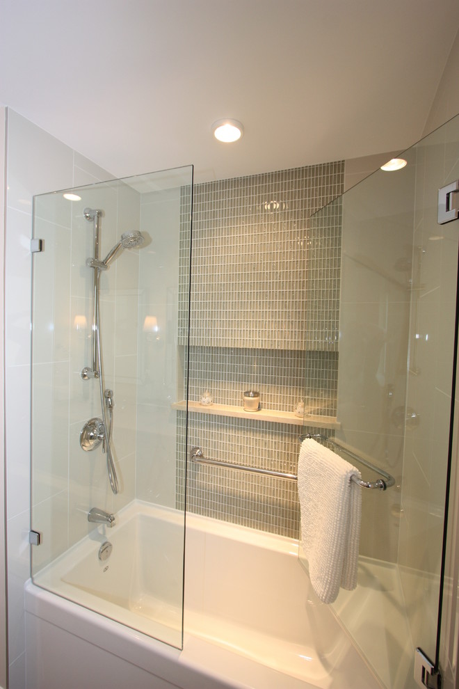 This is an example of a medium sized traditional ensuite bathroom in Vancouver with a submerged sink, recessed-panel cabinets, white cabinets, marble worktops, a shower/bath combination, beige tiles, white walls and lino flooring.