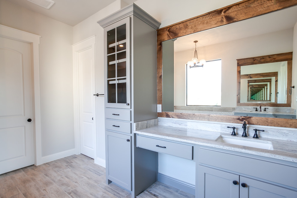 Inspiration for a large traditional ensuite bathroom in Dallas with shaker cabinets, blue cabinets, a built-in bath, a built-in shower, beige tiles, ceramic tiles, beige walls, ceramic flooring, a submerged sink, granite worktops, beige floors and a hinged door.