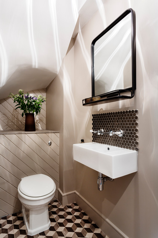 Exempel på ett modernt badrum, med brun kakel, beige väggar och ett väggmonterat handfat