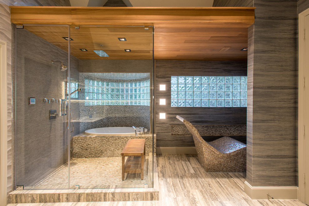 Cette image montre une grande salle de bain design en bois brun avec un placard à porte plane, une baignoire posée, un carrelage gris, des carreaux de porcelaine, un mur gris, un sol en marbre, un plan de toilette en marbre et une cabine de douche à porte battante.