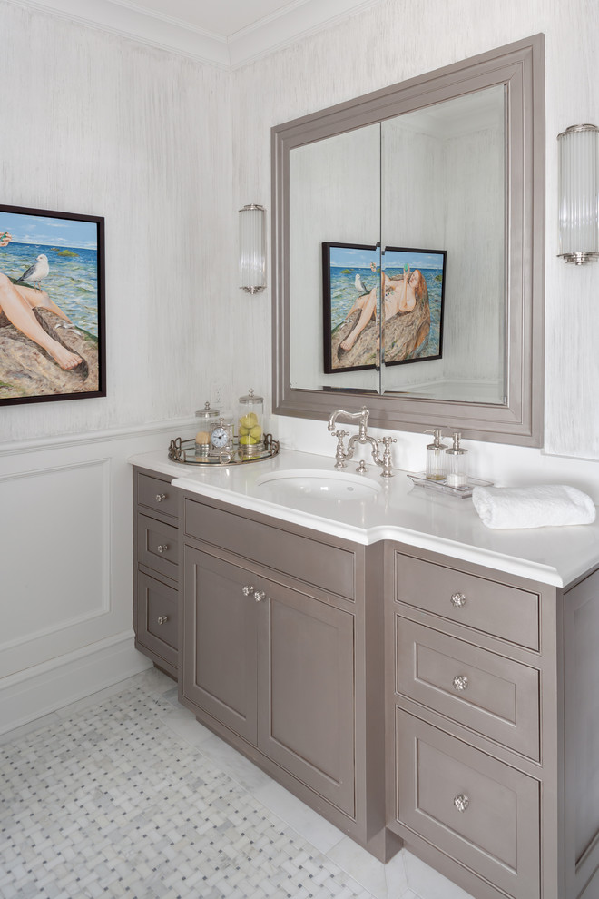 Medium sized traditional bathroom in New York with recessed-panel cabinets, grey cabinets, a submerged sink, white walls and marble flooring.