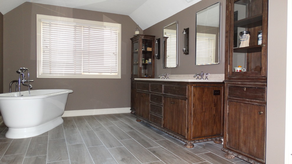 Bathroom - large modern master bathroom idea in Cleveland with furniture-like cabinets, dark wood cabinets, brown walls, marble countertops and an undermount sink