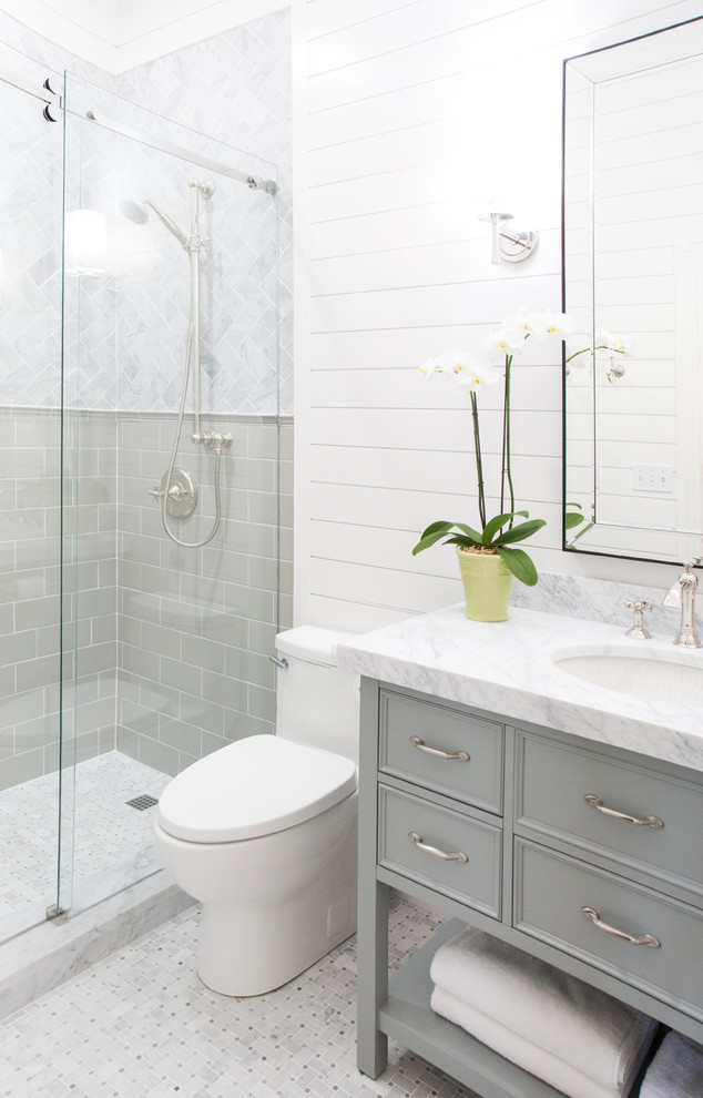 Mid-sized arts and crafts 3/4 gray tile and marble tile mosaic tile floor and gray floor sliding shower door photo in Austin with beaded inset cabinets, green cabinets, a one-piece toilet, white walls, an undermount sink and marble countertops