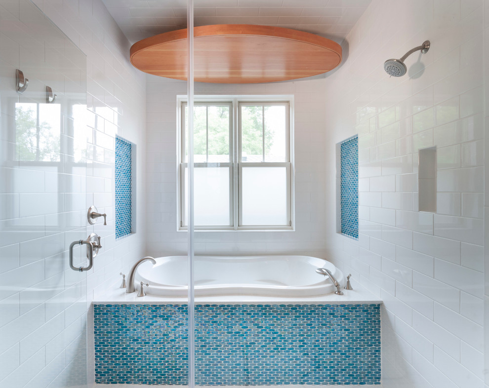 Medium sized traditional ensuite bathroom in Austin with a submerged sink, shaker cabinets, medium wood cabinets, engineered stone worktops, a built-in bath, a shower/bath combination, blue tiles, glass tiles, blue walls and porcelain flooring.