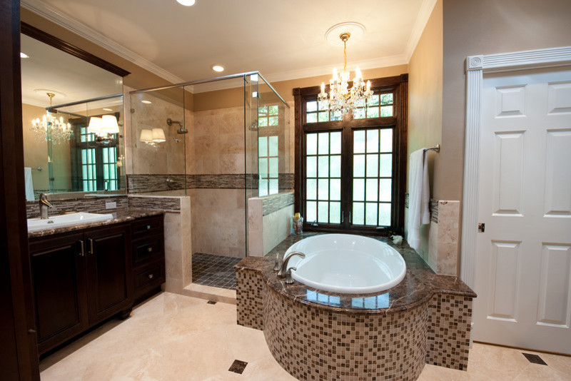 Design ideas for a large traditional ensuite bathroom in Austin with marble worktops, beige tiles, a built-in bath, a corner shower, a built-in sink, beige walls, travertine flooring, raised-panel cabinets, dark wood cabinets, a two-piece toilet, mosaic tiles, beige floors, a hinged door and multi-coloured worktops.