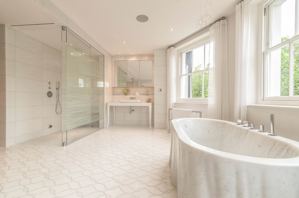 Inspiration for an expansive classic shower room bathroom in London with glass-front cabinets, black cabinets, a freestanding bath, a walk-in shower, a one-piece toilet, white tiles, stone slabs, white walls, marble flooring, a built-in sink and marble worktops.