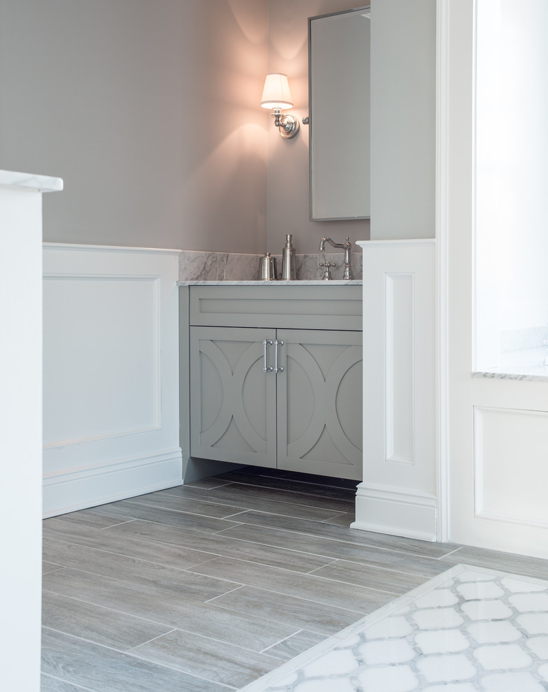 Example of a large transitional gray tile ceramic tile bathroom design in New York with furniture-like cabinets, gray cabinets, marble countertops and gray walls