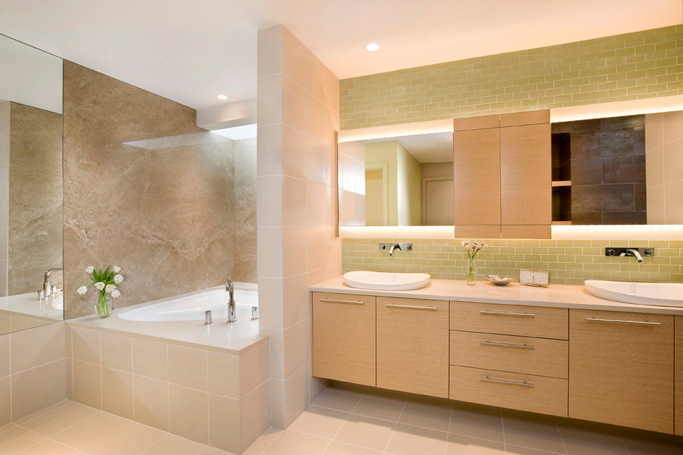 Example of a large minimalist master green tile and subway tile cement tile floor and beige floor bathroom design in Boston with flat-panel cabinets, light wood cabinets, beige walls, a vessel sink, quartz countertops, a hinged shower door and beige countertops