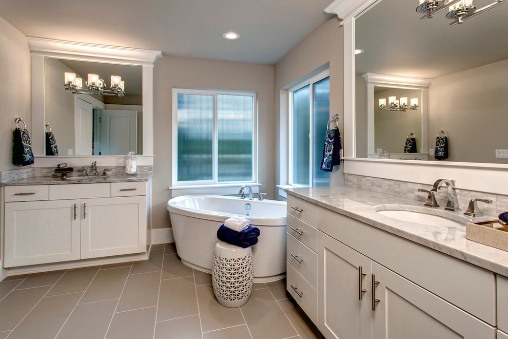 Large transitional master gray tile and porcelain tile laminate floor bathroom photo in Seattle with open cabinets, white cabinets, a one-piece toilet, gray walls, an integrated sink and granite countertops