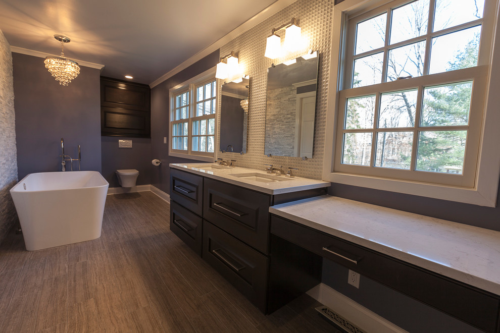 Inspiration for a large contemporary master white tile and porcelain tile porcelain tile and gray floor bathroom remodel in New York with flat-panel cabinets, dark wood cabinets, a wall-mount toilet, purple walls, an undermount sink and quartz countertops