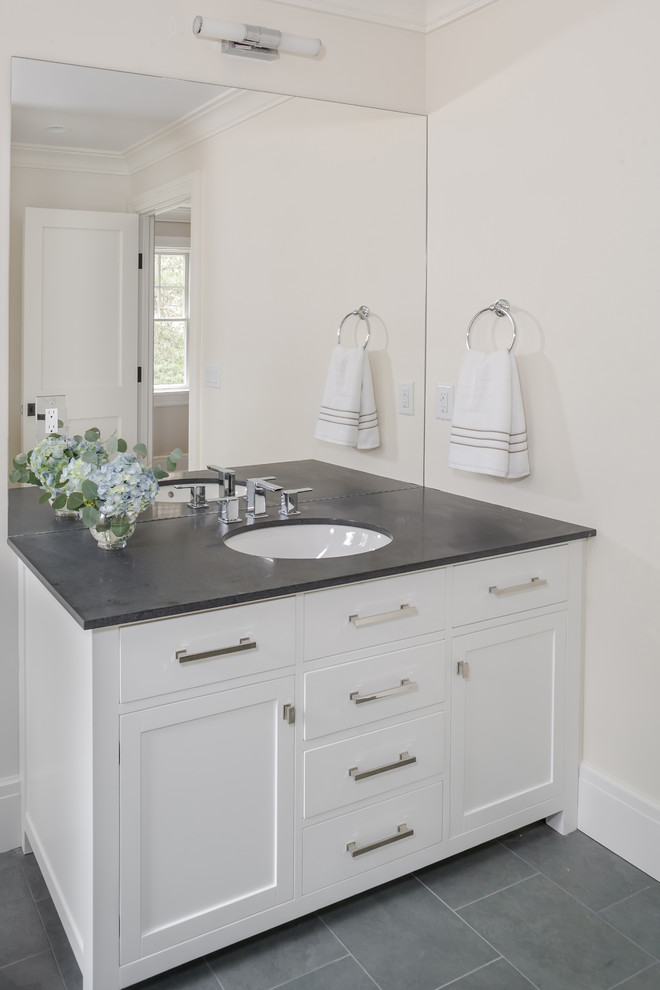 Transitional master slate floor bathroom photo in New York with recessed-panel cabinets, white cabinets, white walls, an undermount sink and solid surface countertops