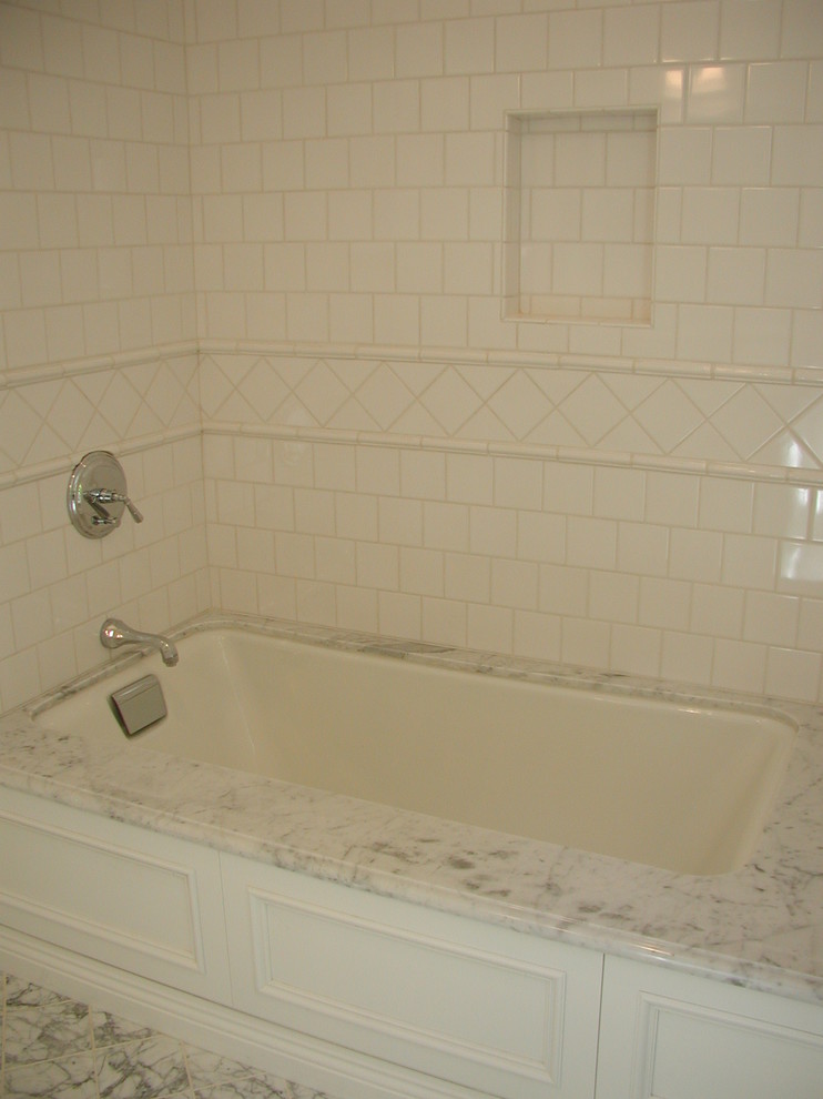 Example of a small classic kids' white tile and ceramic tile marble floor bathroom design in Los Angeles with recessed-panel cabinets, white cabinets, an undermount tub and marble countertops