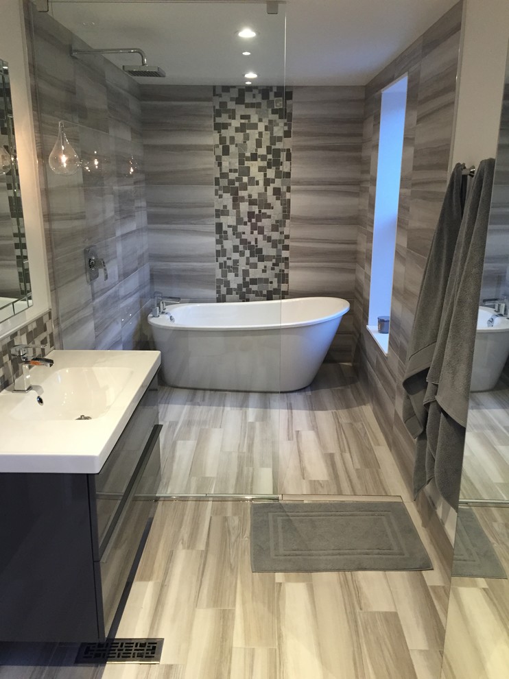 Photo of a medium sized contemporary bathroom in Other with a freestanding bath, a built-in shower, grey tiles, porcelain tiles, white walls and porcelain flooring.