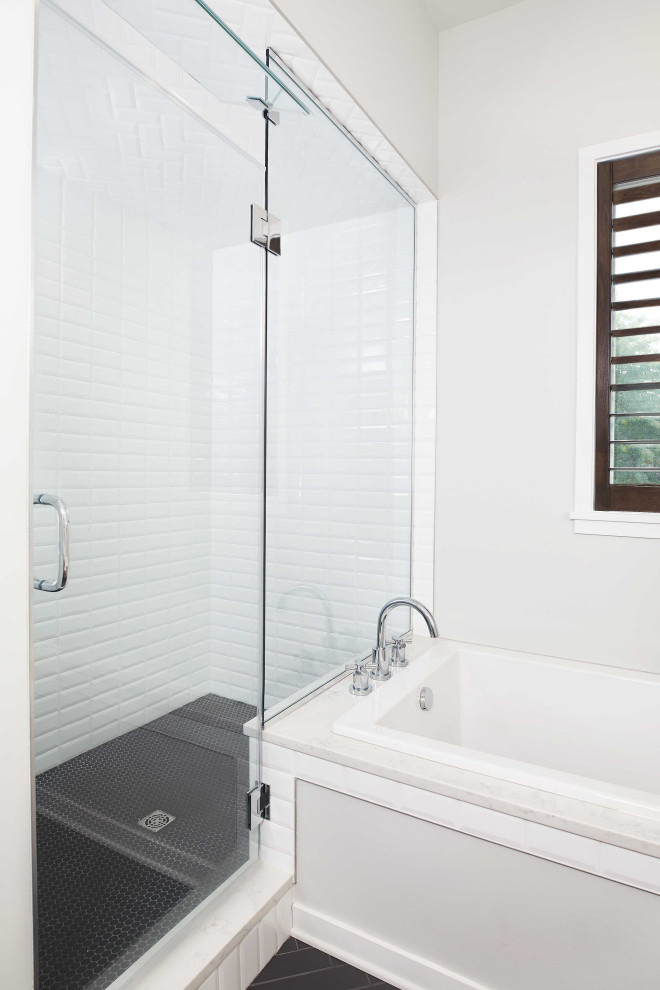 Bathroom - mid-sized contemporary master white tile and porcelain tile ceramic tile and black floor bathroom idea in Grand Rapids with flat-panel cabinets, white cabinets, a two-piece toilet, white walls, an undermount sink, quartz countertops, a hinged shower door and white countertops