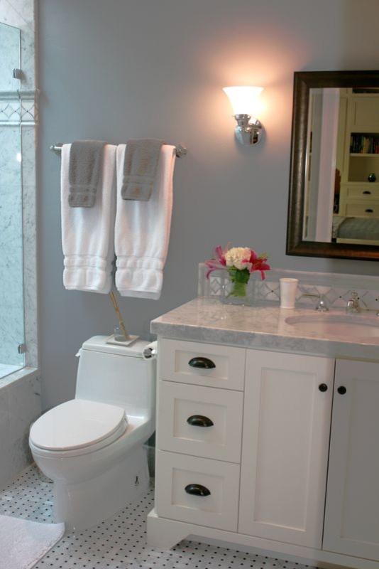 Inspiration for a small coastal gray tile and mosaic tile porcelain tile bathroom remodel in Orange County with an undermount sink, a one-piece toilet, recessed-panel cabinets, white cabinets, marble countertops and blue walls