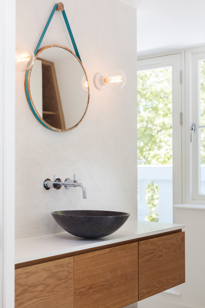 Photo of a small scandinavian ensuite bathroom in London with flat-panel cabinets, medium wood cabinets, quartz worktops and a built-in shower.