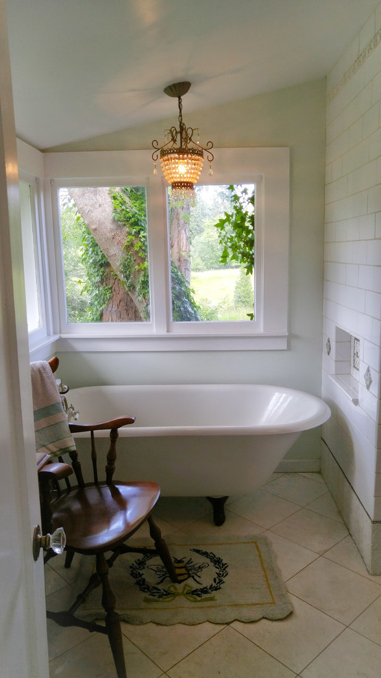 This is an example of a medium sized beach style ensuite bathroom in Seattle with freestanding cabinets, blue cabinets, a claw-foot bath, a walk-in shower, white tiles, ceramic tiles, blue walls, marble flooring, a pedestal sink and white floors.