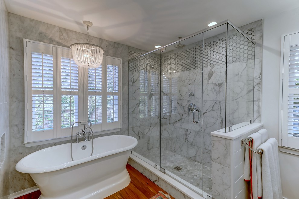 Inspiration for a large contemporary master gray tile and marble tile light wood floor and brown floor bathroom remodel in Charleston with blue cabinets, white walls, a drop-in sink, marble countertops and a hinged shower door