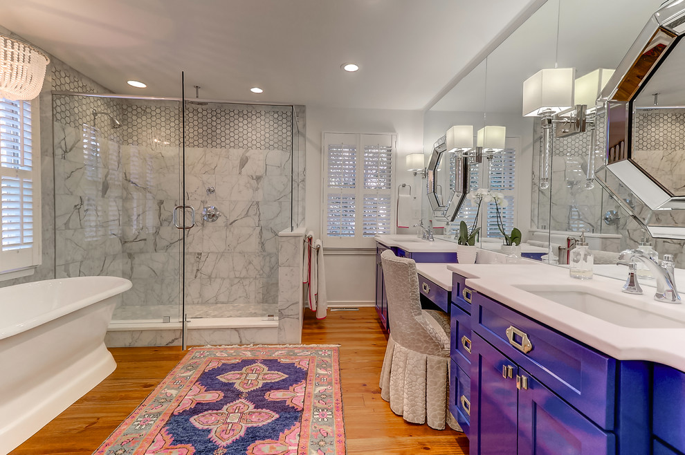 Inspiration for a large contemporary ensuite bathroom in Charleston with blue cabinets, a freestanding bath, a corner shower, grey tiles, marble tiles, white walls, light hardwood flooring, a built-in sink, marble worktops, brown floors and a hinged door.