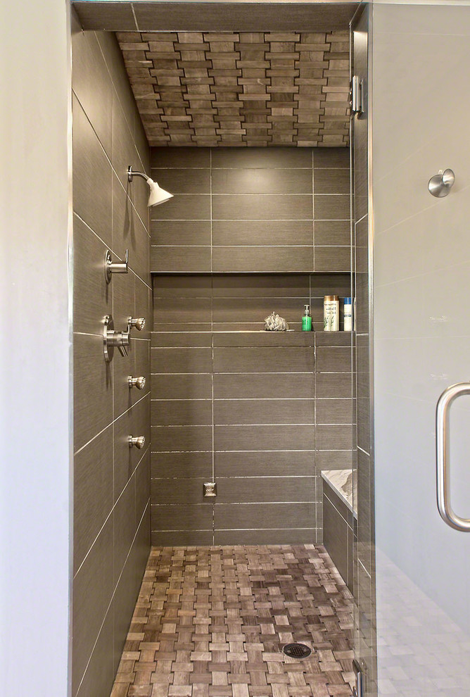 This is an example of a medium sized contemporary ensuite bathroom in Chicago with flat-panel cabinets, grey cabinets, a freestanding bath, an alcove shower, grey tiles, ceramic tiles, grey walls, ceramic flooring, a submerged sink and marble worktops.