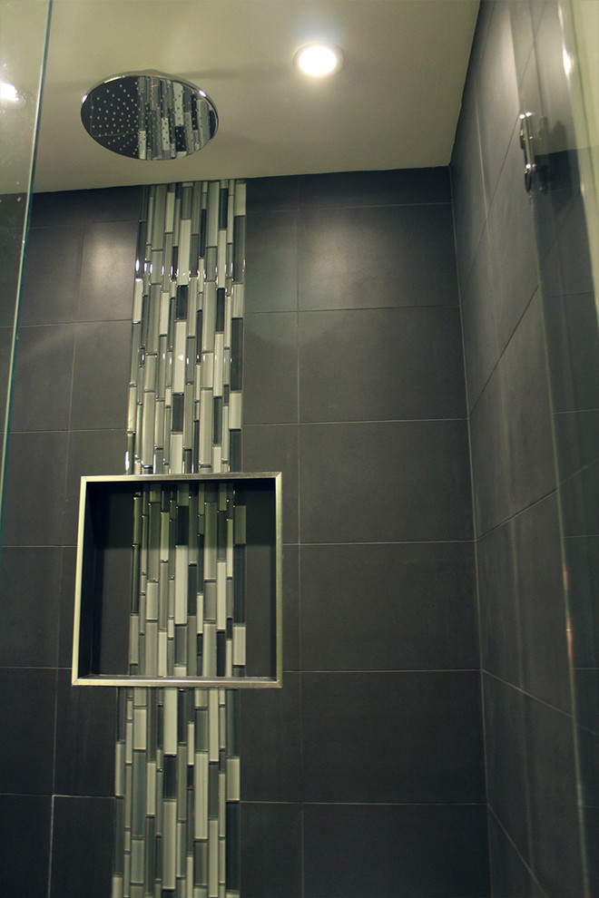 Example of a mid-sized trendy master gray tile and stone slab porcelain tile alcove shower design in Vancouver with an undermount sink, flat-panel cabinets, dark wood cabinets, quartz countertops, a two-piece toilet and beige walls