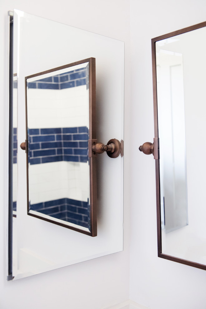 Example of a mid-sized transitional 3/4 white tile and subway tile dark wood floor and brown floor alcove shower design in San Diego with shaker cabinets, blue cabinets, a two-piece toilet, white walls, an undermount sink, solid surface countertops and white countertops