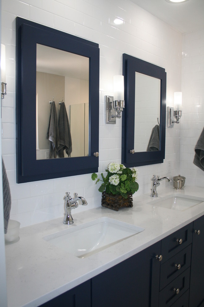 Elegant white tile and ceramic tile marble floor and white floor alcove shower photo in Albuquerque with recessed-panel cabinets, blue cabinets, a two-piece toilet, white walls, an undermount sink, quartz countertops and a hinged shower door