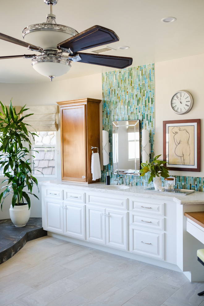 Inspiration for a large coastal master blue tile and glass tile porcelain tile and beige floor bathroom remodel in San Diego with raised-panel cabinets, white cabinets, a one-piece toilet, white walls, an undermount sink, quartz countertops and white countertops